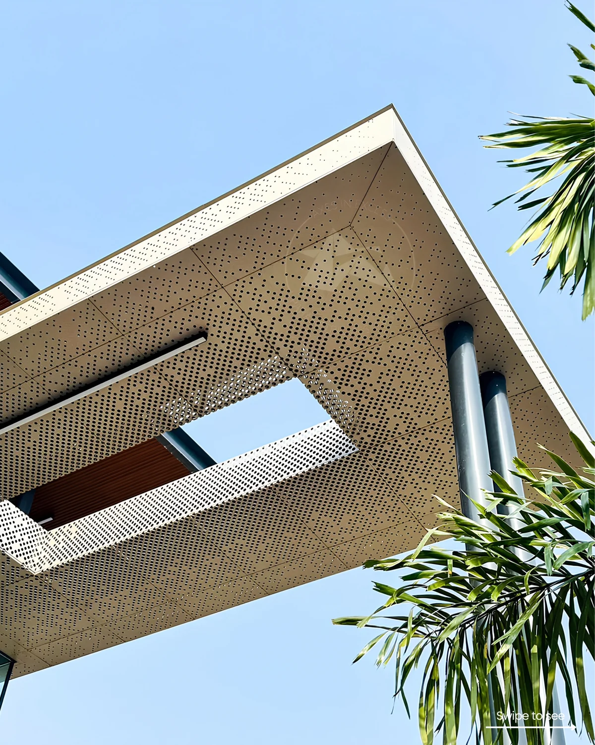 Upward view of a pale perforated canopy with rectangular sky openings, cylindrical columns and foliage.
